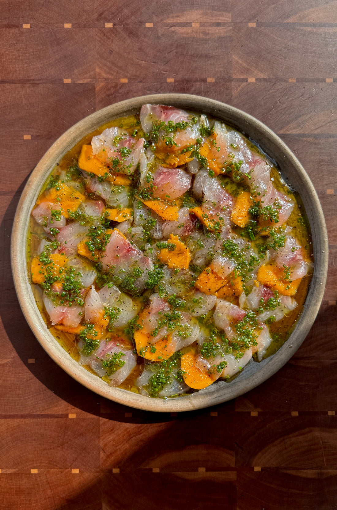 STRIPED BASS CRUDO WITH BABY MANGO & PONZU VINAIGRETTE